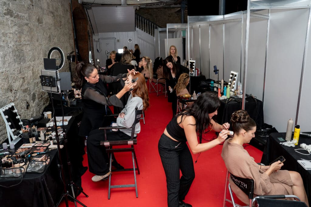 Backstage at The Wedding Show Ireland with Keira Smyth bridal hair and makeup team styling models before the runway.
